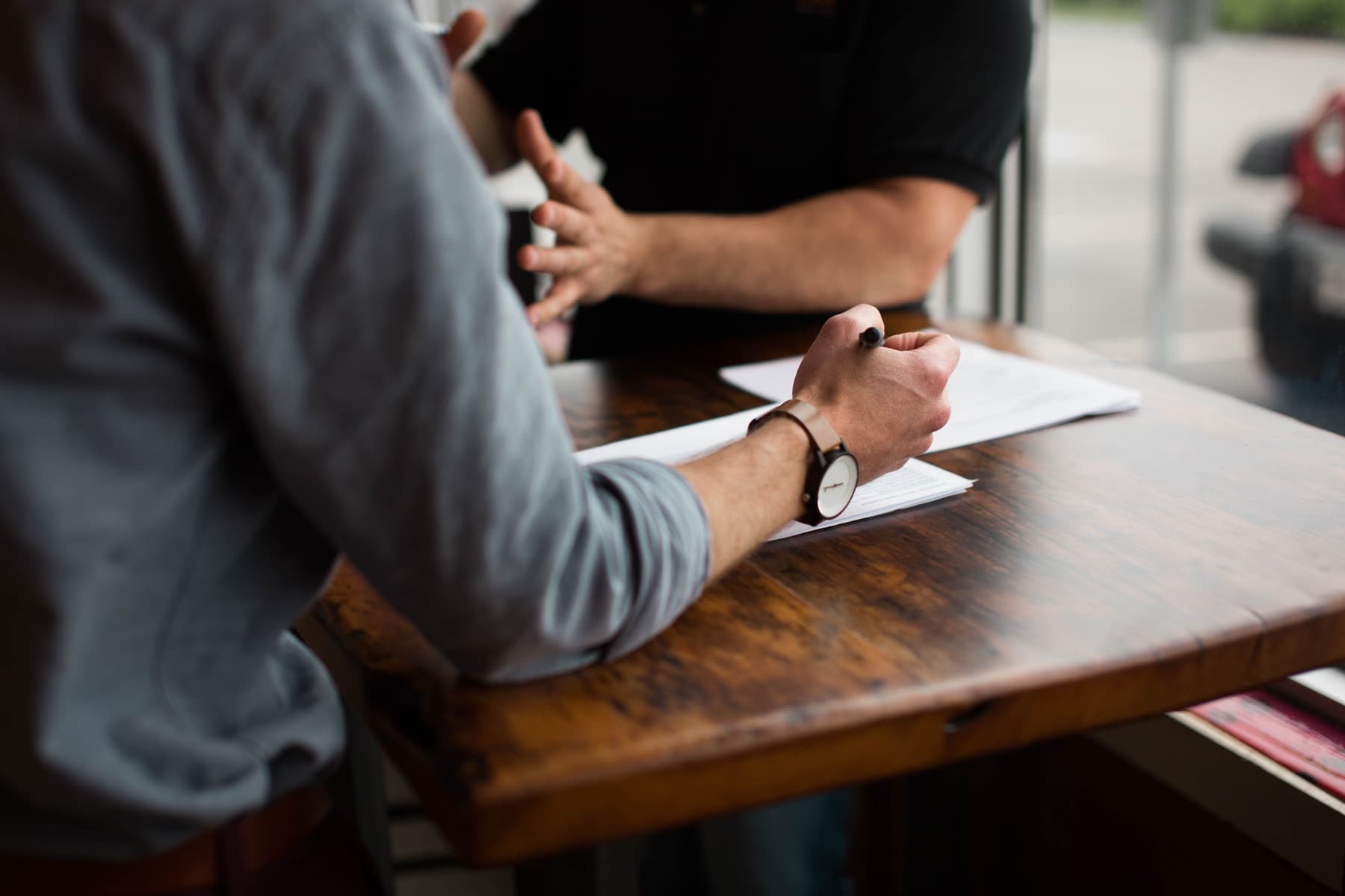 Two people chatting over a contract