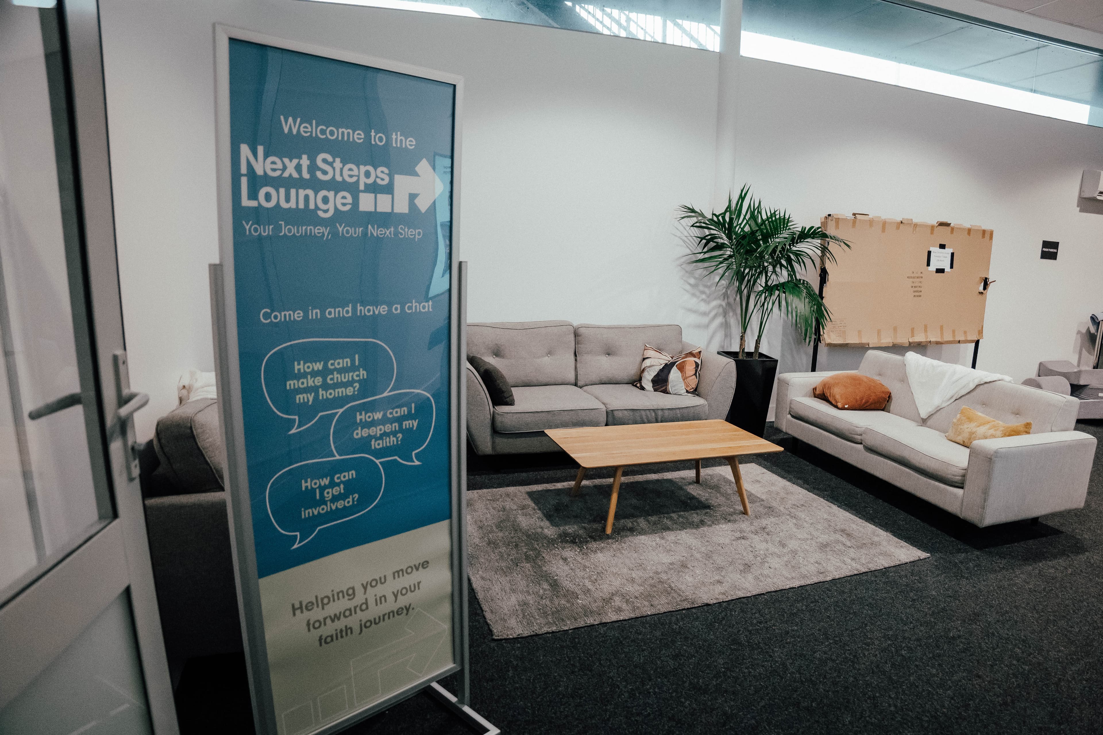 Next Steps Lounge at North Campus looking like a comfy lounge with a NSL standing sigh