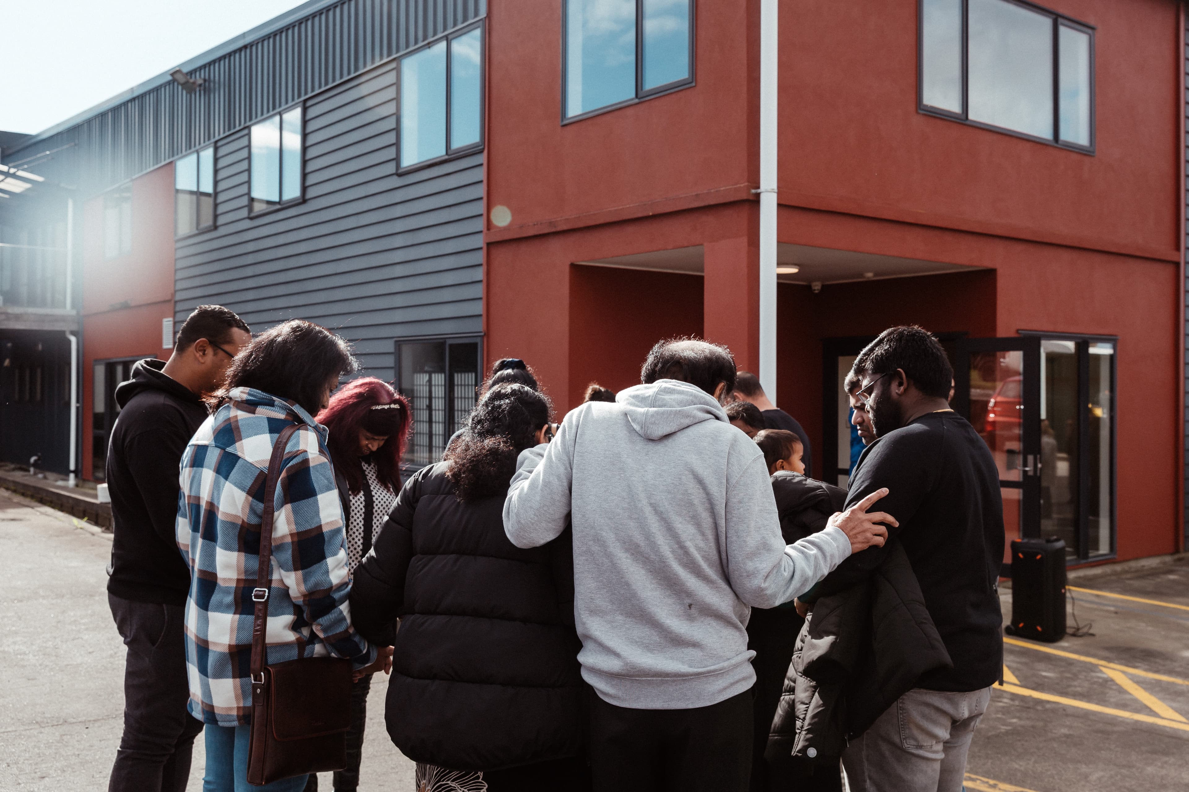 People praying outside the new West Campus building