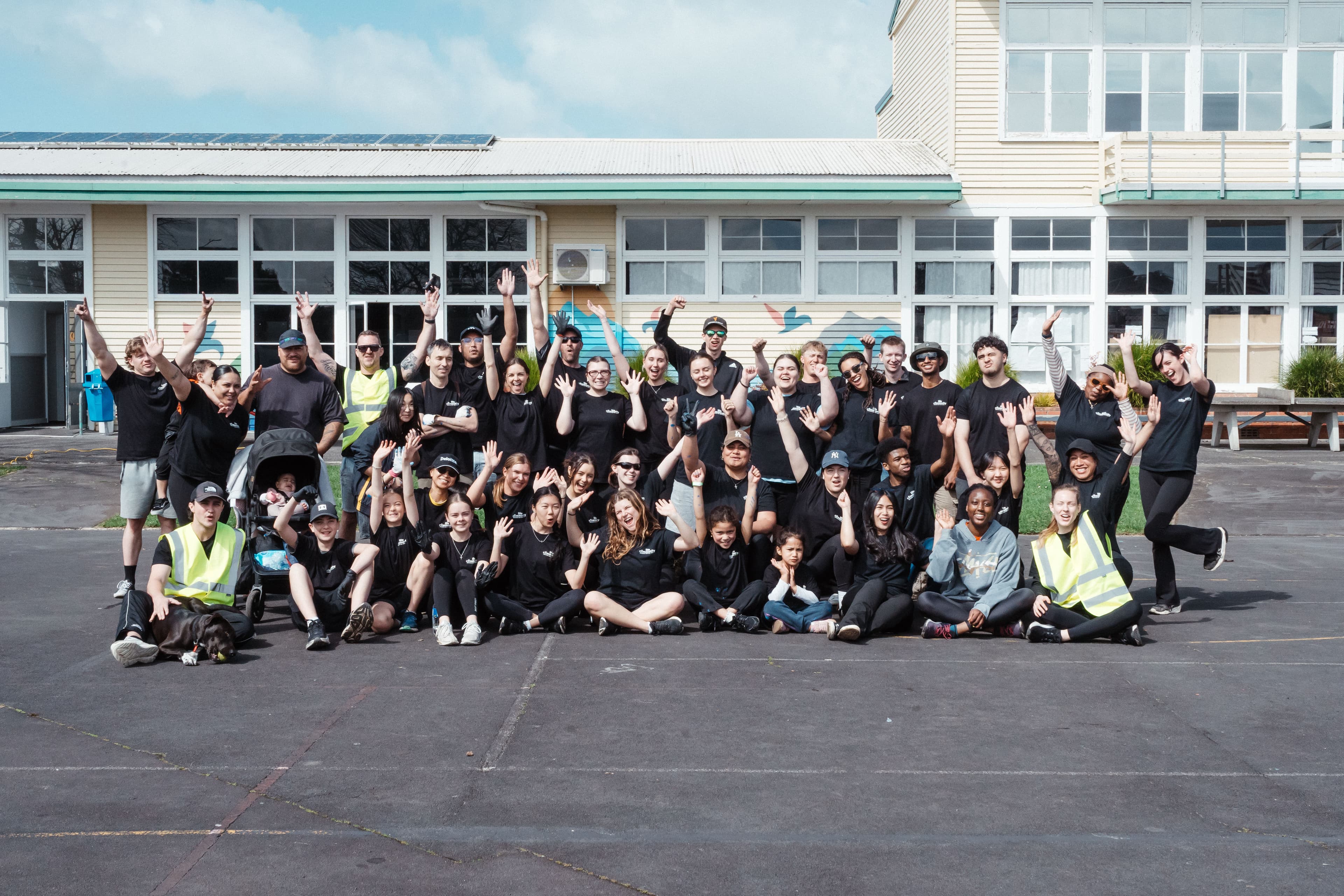 Group of volunteers standing together at a school for Help & Hope Week