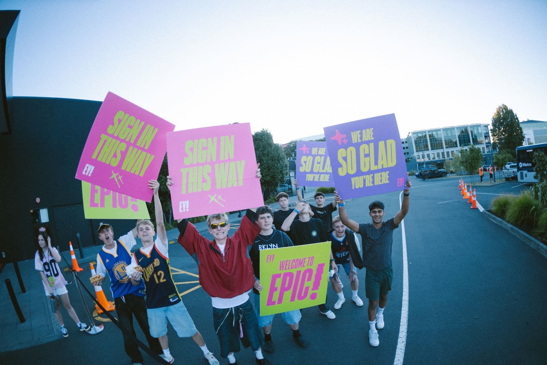 Youth Kids welcoming people in with signs at the central carpark