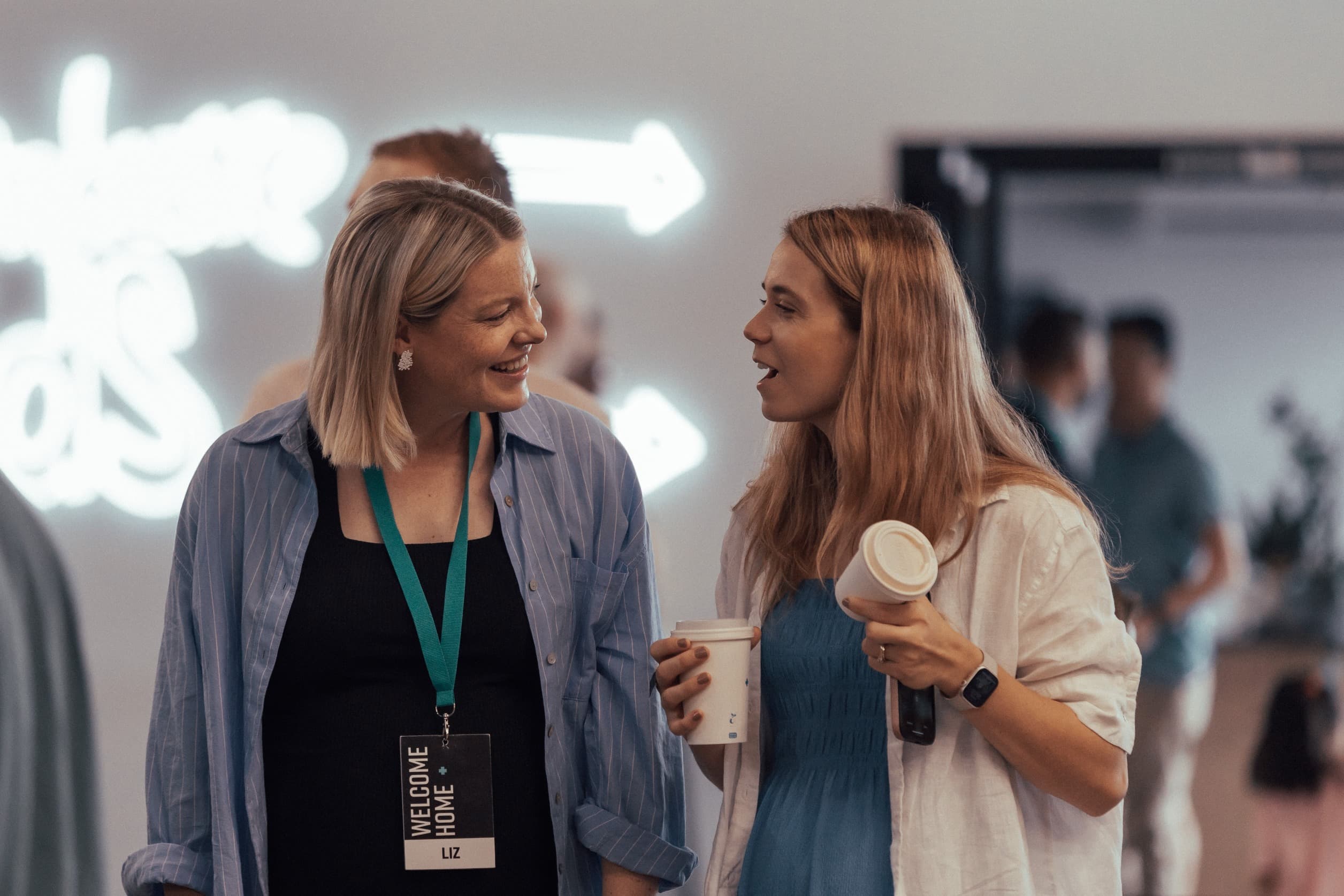 A service host chatting with someone in the foyer