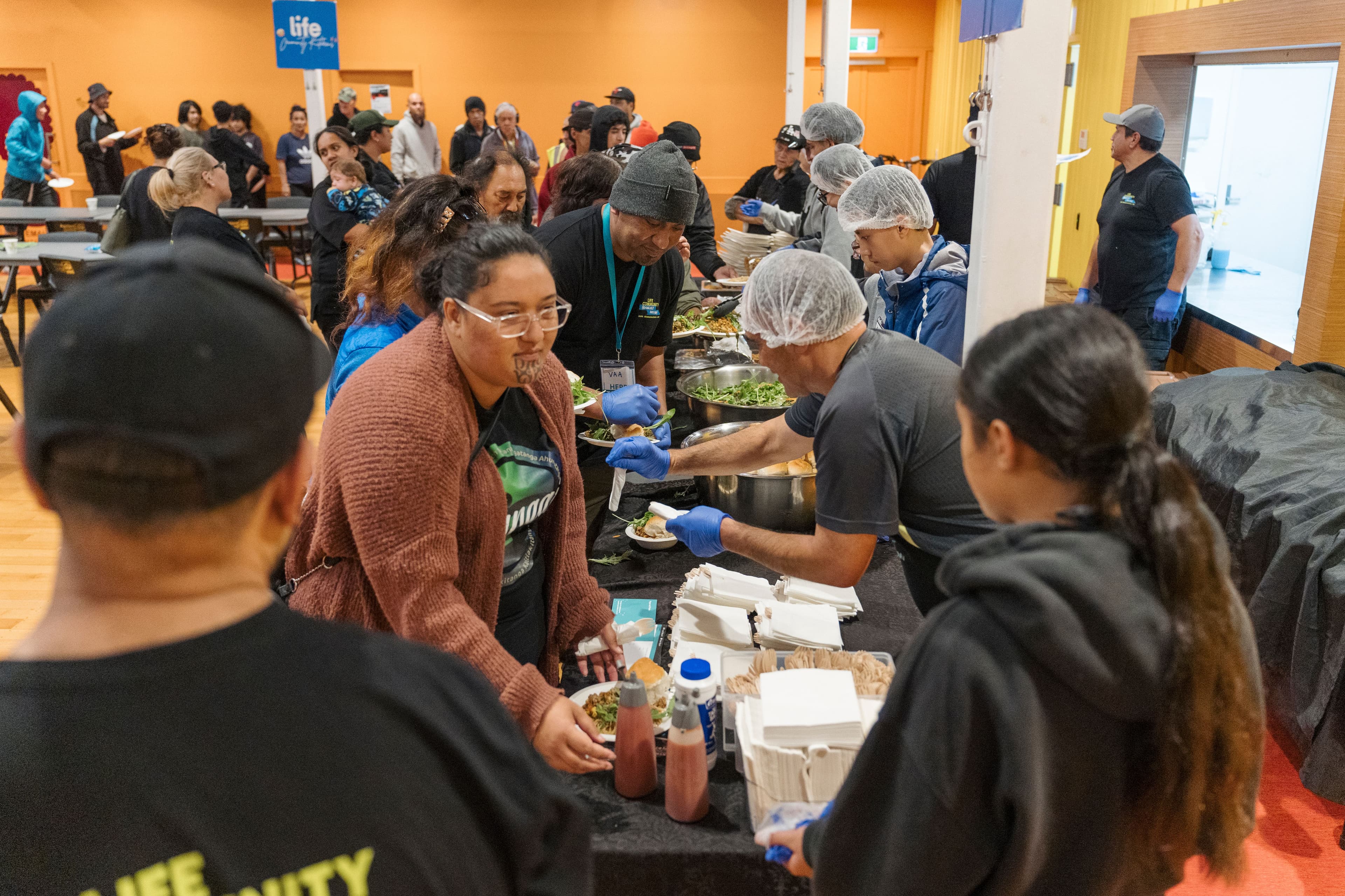 People being served dinner at a LIFE Community Kitchen