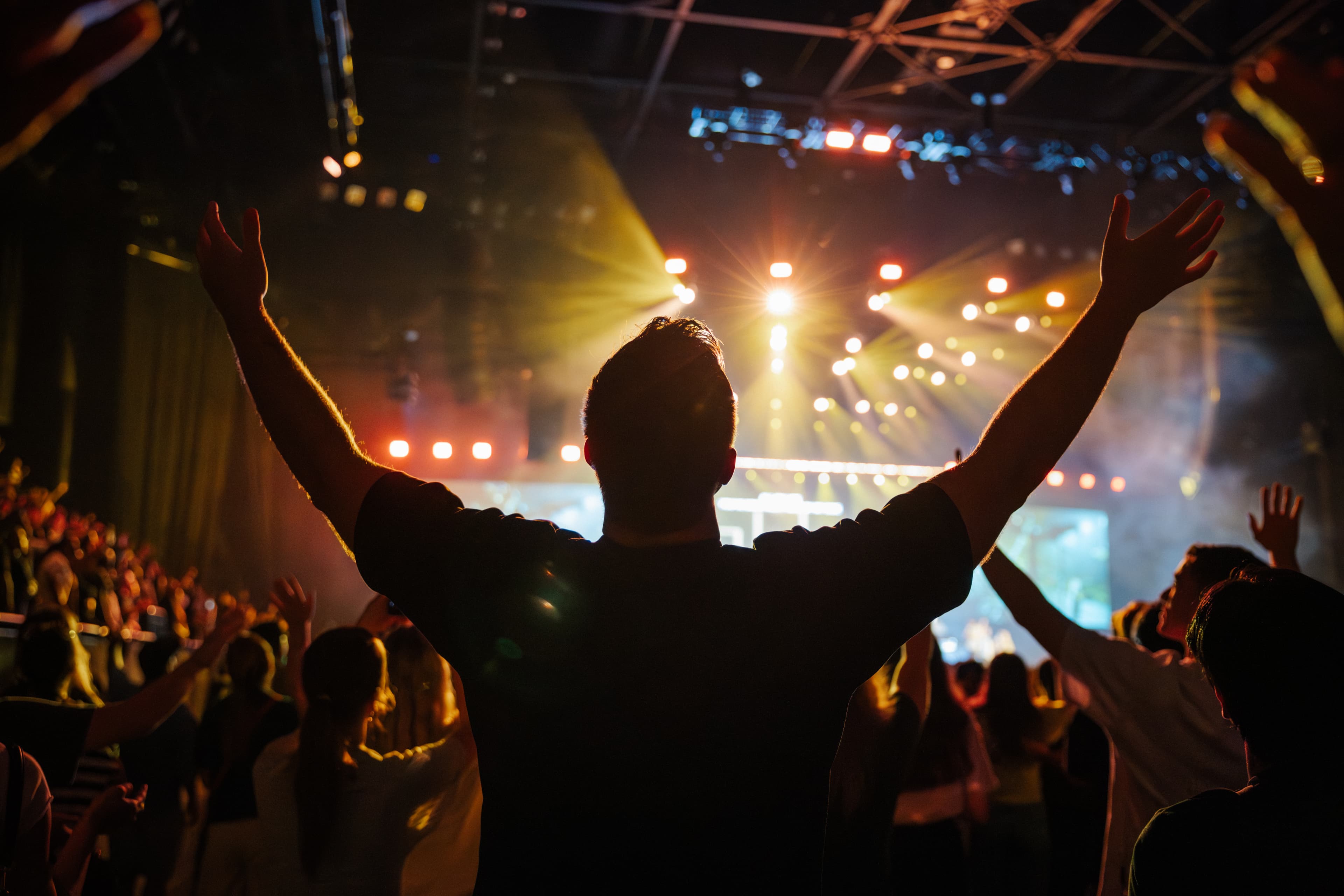Man at Open Heaven with arms raised in worship
